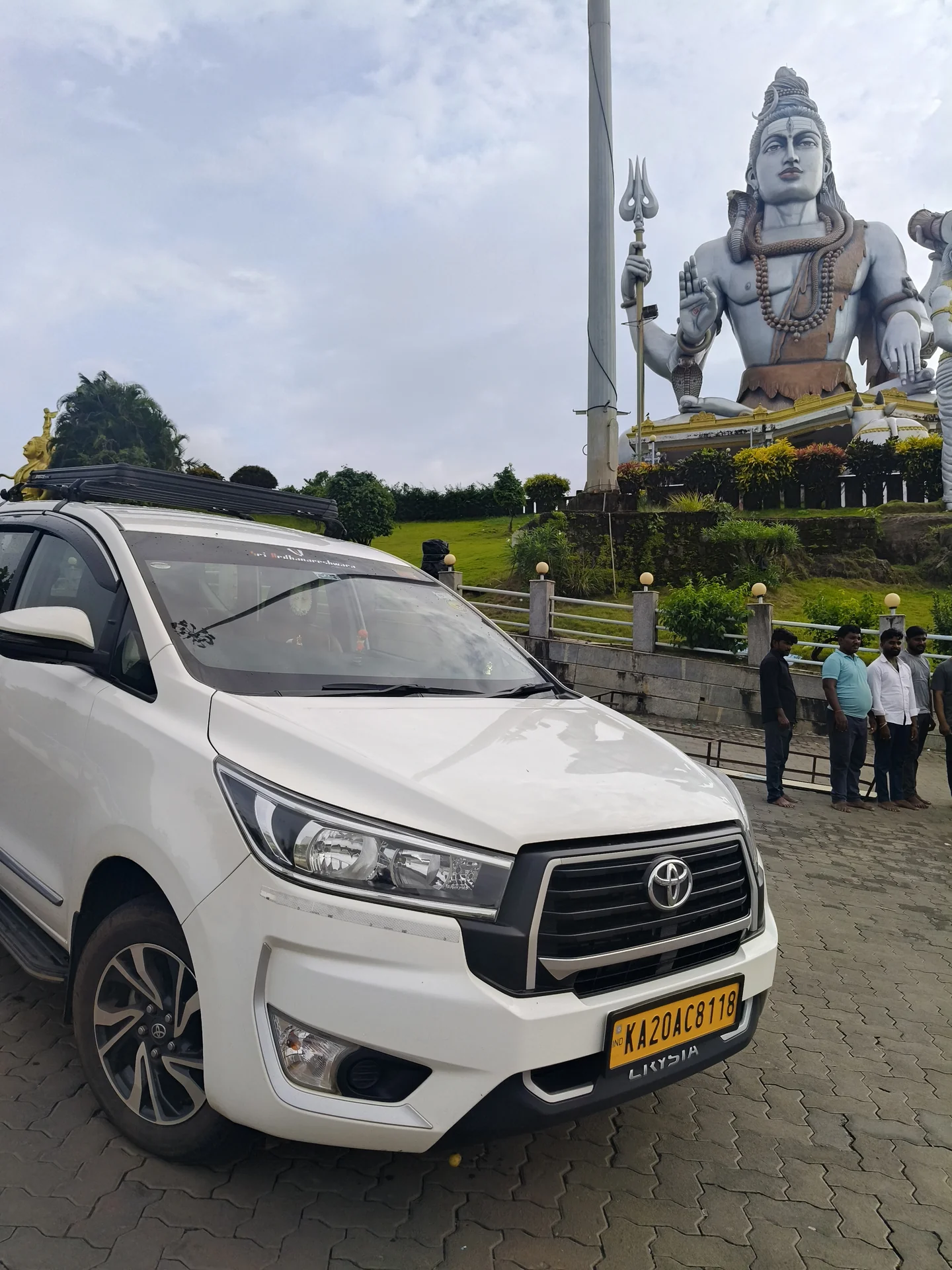 Side profile view of Atharv Cabs Innova Crysta showing spacious body and roof carrier