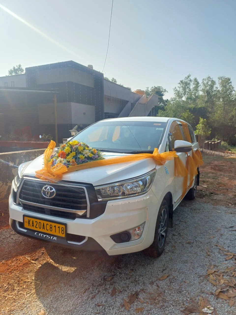 Decorated Innova Crysta with wedding ribbon streamers on side door handles and bonnet
